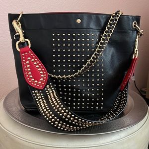 Sharif Saffiano leather tote. Black with gold tone headwear and red accents.